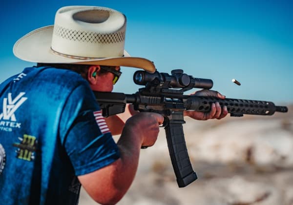 Competition shooter firing a JP rifle at the range